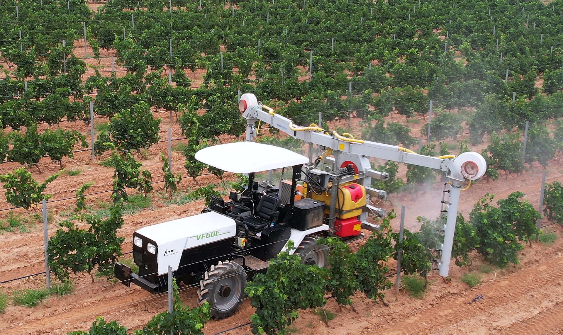VF60E compact electric tractor spraying in a vineyard